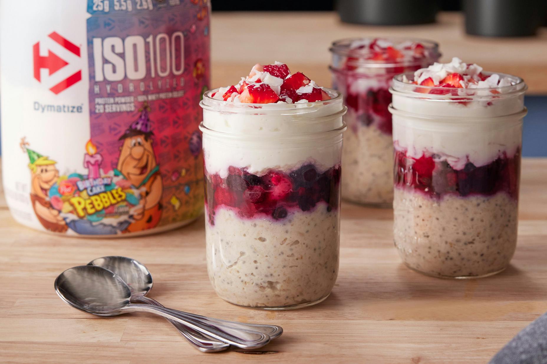 Maria’s Protein Overnight Oats with a tub of Dymatize ISO100 Pebbles Birthday Cake Protein Powder